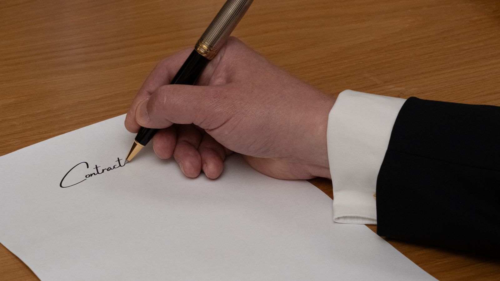 Legal text and pen on a desk, illustrating the legal basis for B2B e-invoicing in Belgium