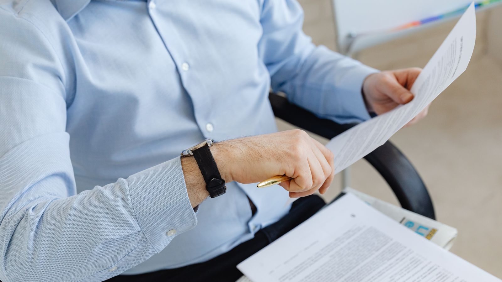 Belgian business owner reviewing registration documents at a desk, illustrating the difference between a company number and a VAT number